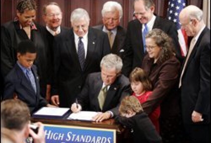 President Bush signs the IDEA law.