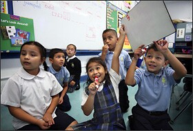 First graders work together to answer a question before other teams in a class a Mother of Sorrows School in Los Angeles. Like many Roman Catholic and other private schools, Mother of Sorrows is shifting to the Common Core State Standards.