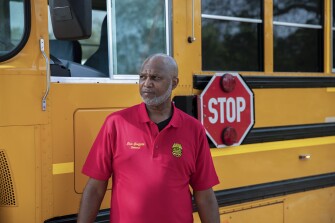 Eric Griffith, 55, poses for a portrait in front of a school bus in Jacksonville, Fla. on Thursday, March 18, 2021. Griffith, who has been a school bus driver for 20 years, delivered meals and educational materials during the first couple months of the coronavirus pandemic when schools shifted to remote learning.