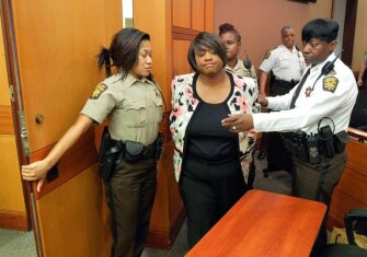 Former Atlanta Public Schools school research team co-director Tamara Cotman, center, is led to a holding cell after a jury found her guilty in the test-cheating trial.
