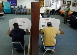 Regina Gatti, left and her husband Joseph Gatti, vote at the town hall in Livingston, N.Y.