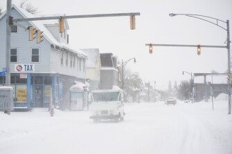 A postal truck makes its way down Grant Street during a snowstorm, Saturday, Nov. 19, 2022 in Buffalo, N.Y.