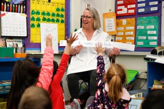 Students raise their hands to suggest names for the newly-hatched chicks in Cynthia Christopher’s kindergarten class.