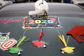 A roll of toilet paper sits on an antenna of a car during a graduation parade for Bixby High School seniors on Thursday, May 7, 2020.
