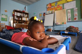 Children lie down during naptime at a preschool program in a building near the now-shuttered Mildred Jackson Elementary School in Hughes. The parents of these children must decide in a year or two whether to put them on a school bus for the hourlong trip to West Memphis schools or move closer.