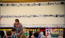 Kindergarten teacher Heather Long helps her students with an art project at Horace Mann Elementary School in St. Paul, Minn. Though Minnesota is funding full-day kindergarten for the first time this year, the state only requires districts to offer a half-day program.