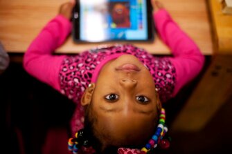 Erie’Onna Seaster, 3, and other children at the Crescent Early Learning Center in Pittsburgh’s Homewood neighborhood use an app-based activity to support “high-quality talk” among children, parents and teachers.
