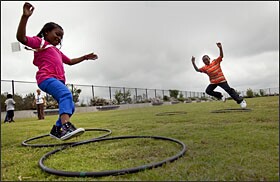 Students take part in structured activities during recess on their playground atop a three-story parking garage in Charlotte, N.C.