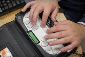 Logan Kelly, 18, uses a computer and Braille note-taking device in a computer class at Perkins School for the Blind in Watertown, Mass.