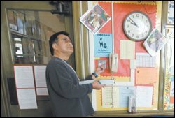 Roger Chang, a Los Angeles County school facilities inspector, tests a light switch at Lincoln Elementary School in Pomona, Calif. As part of a 2004 legal settlement, California's lowest-achieving schools are routinely inspected to make sure that they are clean and safe, and that students have enough materials.