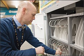 Townsley checks on a MacBook Air cart at Lakeview Elementary School in Solon. Like many chief academic or technology officers, he was a teacher before taking on his district role.