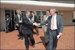 Daniel Larsen (right), shaking hands with Congressman Mark Kirk after the politician's school visit, teaches students to participate in Democracy.