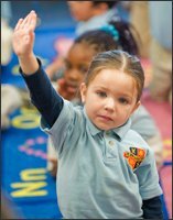 Pre-K-3 pupil Marifer Brenner raises her hand to answer a question.