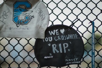 Swim caps with messages of mourning for beloved coach Kerry Croswhite.