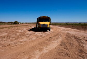 A school bus waits for STAR School students as they spend time at the North Leupp Family Farm on the Navajo Nation in Leupp, Ariz.