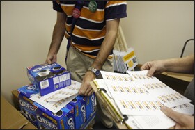 Pro-voucher volunteers collect signs and boxes of cookies for distribution at the Parents for Choice in Education headquarters. Though Utah’s voucher proponents have fielded teams of supporters throughout the state, those opposed to the program enacted earlier this year have received more financial backing in their bid to overturn it in next month’s referendum.