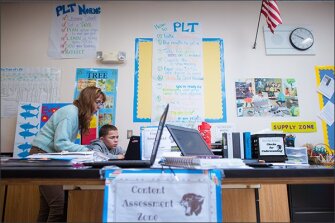At E-Cubed Academy in Providence, R.I., inclusion special education teacher Barbara Hoy helps 9th grade student Anthony Harrison with a biology lesson.