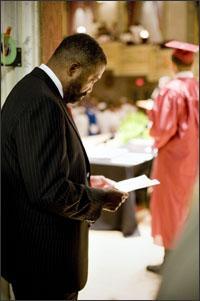 Robert C. Bobb, the emergency financial manager of the Detroit district, reviews his speech before the commencement exercises for summer school on July 24.