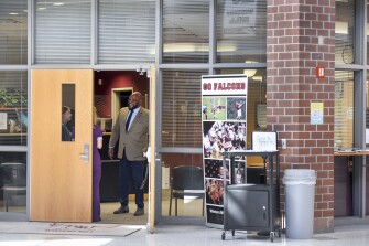 Principal Michael C. Brown talks with a student and her mother at Winters Mill High School in Westminster, Md., Tuesday, May 17, 2022.