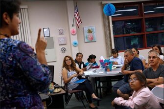 Liliana Valadez teaches parents about types of financial aid for college during a session organized by PIQE, or the Parent Institute for Quality Education, in Modesto, Calif. The group has taught more than 624,000 parents to advocate for their children since its inception 30 years ago. Many parents in the community are immigrants who are unfamiliar with the ways of U.S. schools and colleges.