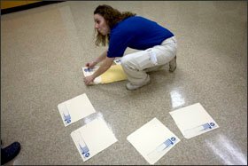 Michele Montrella, a youth consultant at the institute, organizes contestants’ answer sheets while proctoring the test.