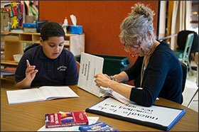 Desmond Dones, 11, works on reading with special education teacher Linda Luthman at Burncoat Preparatory.