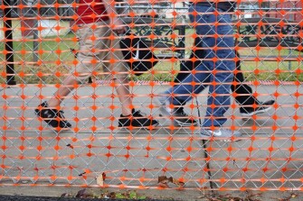 Students walk between classes at Collins Middle School in Fayette County. The orange fencing stands between them and a building that closed in January 2015, because it was deemed unsafe for student occupancy.