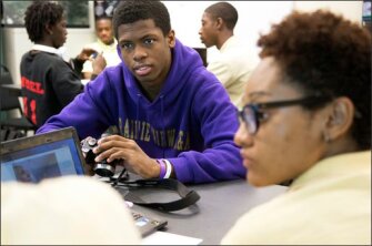 Devonte Perry-McCullum, center, works on a photography assignment during his science class at Innovations High School, a reflection of the school’s emphasis on integrating the arts into core academic subjects. Innovations was the Chicago student's third try at high school. Now firmly back on track, Perry-McCullum was accepted to six of the seven colleges to which he applied this school year.