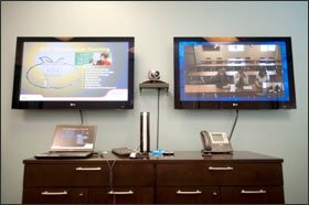 Two screens at the Mary Lou Fulton Teachers College on the Phoenix campus of Arizona State University showcase online professional-development content and video interaction.