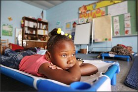 Children lie down during naptime at a preschool program in a building near a now-shuttered elementary school. The parents of these children must decide in a year or two whether to put them on a school bus for the hourlong trip to West Memphis schools or move closer.