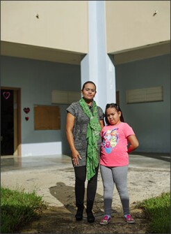 Teacher Jessenia Roberto M. Rivas stands with her daughter, Anngelyn D. Pagan Roberto, a 3rd grader, in the courtyard of Jaime Coira school in Ciales, Puerto Rico. Rivas says she is focusing on preparing her students for standardized tests in the spring.