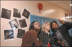From left, Edison executives Sarah Horsey and Jodie Beckley listen as Camille Bell, the principal of Montebello Elementary School, points out student projects.