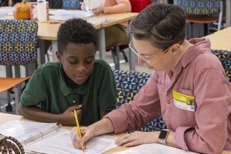 Volunteer tutor Melissa McBerkowitz and Damari White, 10, take part in the new WakeTogether tutoring program designed to help Wake County elementary students recover from pandemic learning loss Thursday, Nov. 17, 2022 at Southeast Raleigh Elementary School.