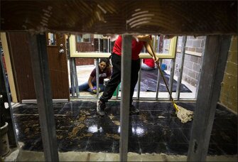 Andres Villagomez and Karen Romero clean up around the floors and studs at Thompson Intermediate School, part of Pasadena Independent School District. Many Houston area schools suffered some sort of damage from Hurricane Harvey.