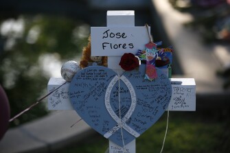 Jose Flores' cross stands at a memorial site for the victims killed in this week's shooting at Robb Elementary School in Uvalde, Texas, Friday, May 27, 2022.