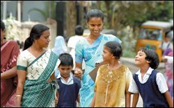 Mothers dressed in the traditional saris of India, walk their children home from the Sri Sankara Vidyalaya primary school in Chennai.
