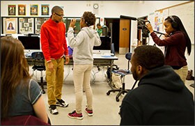 Hyde Park Academy High School juniors Jauan Vinson, at left, and Sarah Thompson act out a police-interaction scenario as classmate Bryanna Huges films during broadcasting class in Chicago. The school is part of a program that aims to improve perceptions and relationships between minority youth and law enforcement.