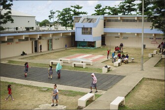 Students mill about the courtyard during school at Guillermina Rosado De Ayala in Loiza, Puerto Rico. The school has power or water for only a few days a week.