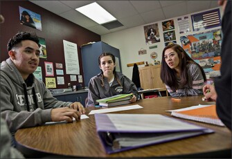 West Wendover High School seniors, from left, Josua Ruiz, Ana Torres, and Joana Hledik discuss crafting legislation around gun control during Kathy Durham’s U.S. Government class.