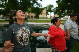 Kladys Castellón prays during a vigil for the victims of a mass shooting at Robb Elementary School in Uvalde, Texas, on Tuesday, May 24, 2022.