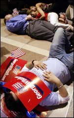 WASHINGTON, United States: Supporters of US President George W. Bush sleep on the floor of the Ronald Reagan Building in Washington at the Republican National Committee election night party 03 November 2004 as the presidential vote was thrown into turmoil as Democratic challenger John Kerry refused to surrender to Bush. The races in the state of Ohio and New Mexico have been called too close to call as broken machines and fatigue halted counting in Iowa.