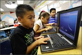 Second graders at Kyrene de los Niños Elementary School display their animal-research reports using virtual tour-sharing on their laptops during class.