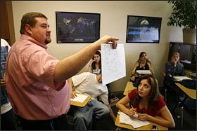 Anna Lerma, left, listens as teacher Rob Werner describes a county during a geography lesson at the Denver Street School's west campus. The school set the model for a national network of small Christian schools that cater to students at high risk of academic failure, including many seeking a second chance at high school.