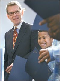 Thomas W. Payzant, who retired last month, is shown with Jose Zayas, 10, the winner of a poetry contest, at a school board meeting in May.