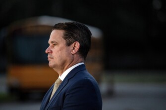 Jefferson County Public Schools Superintendent Marty Pollio waits at the Detrick Bus Compound on the first day of school on Aug. 9, 2023 in Louisville, Ky. An overly-ambitious redesign of bus routes for Louisville's school district turned into a logistical meltdown on the first day of classes, forcing schools to close as administrators said Aug. 11, 2023 that students may have to stay home into part of next week until the mess is untangled.