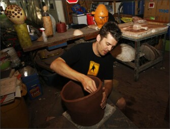 Ben Ahlvers, a ceramicist and arts education coordinator, works on a piece at his home in Lawrence, Kan., on Aug. 29.