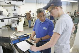 Instructor Joe Espitia advises Robert I. Rayburn, a junior, in a machine shop used by the MTA program on the southwest campus of St. Philip’s College, which is located on a former U.S. Air Force base in San Antonio.