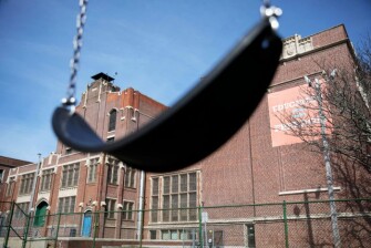 A swing sits empty on a playground outside Achievement First charter school in Providence, R.I. The public charter school, like a nearby Catholic school, closed after a teacher who attended the same Italy trip awaited test results for the new coronavirus. But at Achievement First, the two days off were treated like snow days. There were no special assignments, and no expectation that kids keep up their schoolwork.