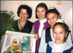 Teacher Jana Sackman Eaton displays a student's artwork in Togliatti, Russia.