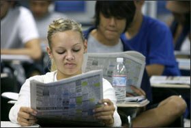 Erica Everett, 18, a senior at Elk Grove High School, checks the news on the stock market during her morning economics class in Elk Grove, Calif., on Sept. 18.